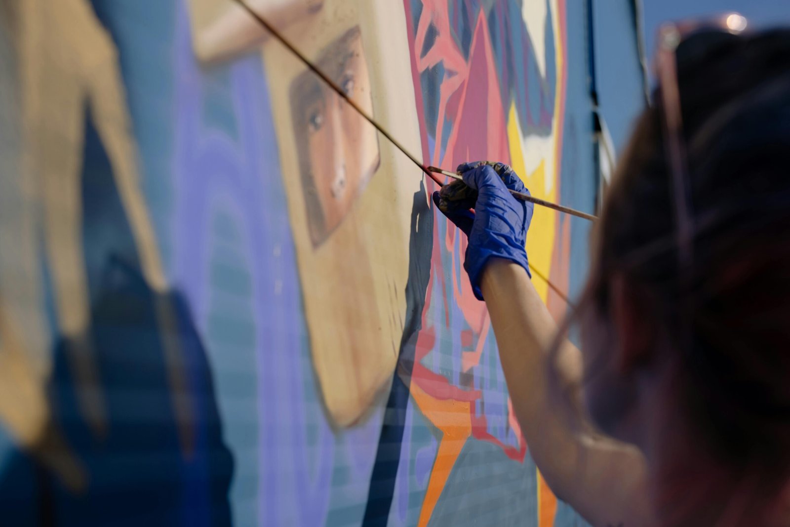 Close-up of an artist creating vibrant graffiti art on an urban wall.